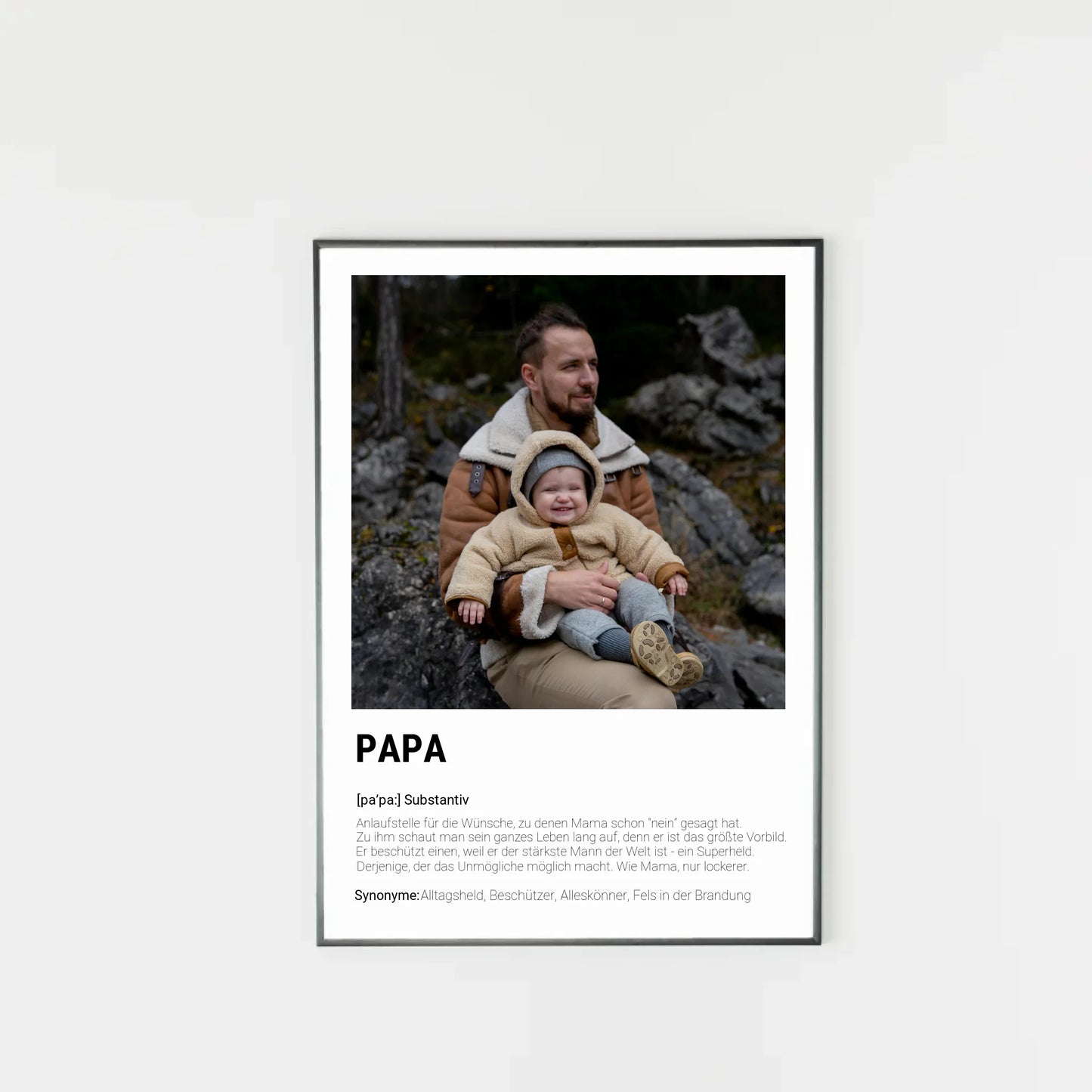 Poster mit personalisierbarem Foto-Bereich im oberen Teil in einem dunklen Holzrahmem. Darunter steht groß das Wort ‚PAPA‘ mit einer Definition in Wörterbuch-Stil. Beschrieben wird der Vater als Alltagsheld, Beschützer, Alleskönner und Fels in der Brandung