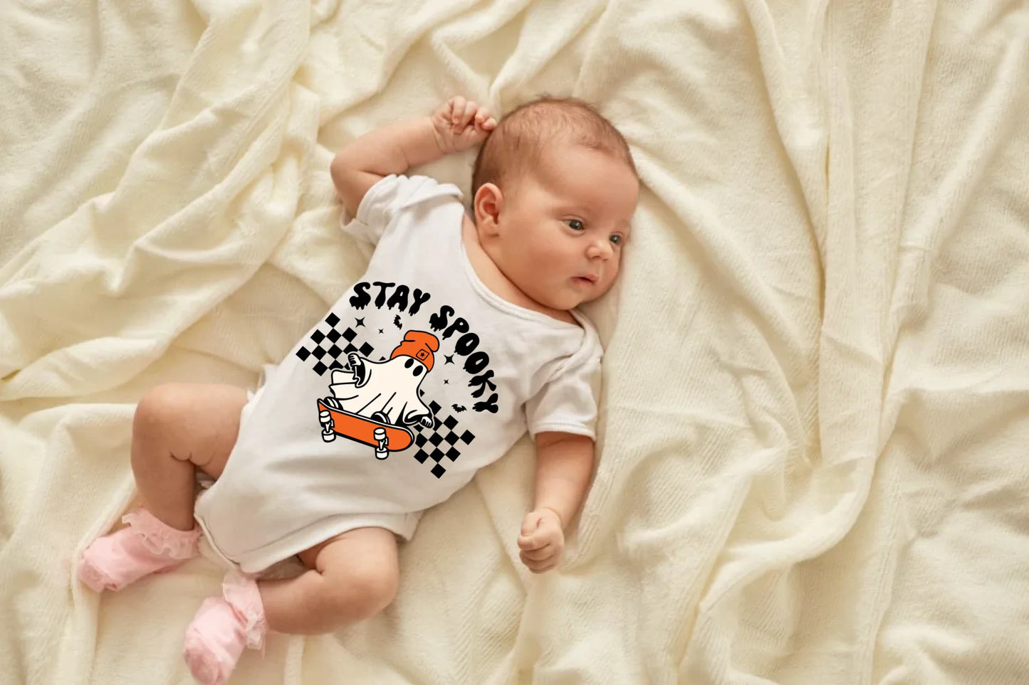 newborn-baby-girl-boy-lying-blanket-bed-looking-away-wearing-white-bodysuit-socks-infant-studying-world-around-has-sleepy-expression