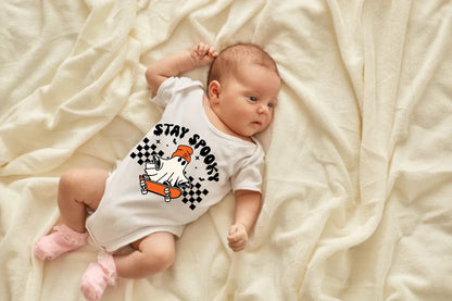 newborn-baby-girl-boy-lying-blanket-bed-looking-away-wearing-white-bodysuit-socks-infant-studying-world-around-has-sleepy-expression